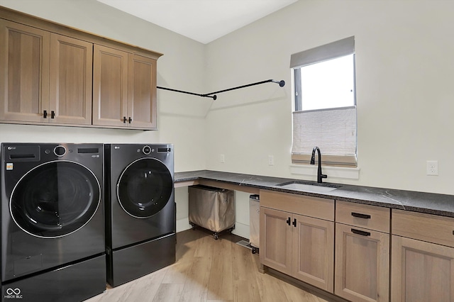 7116 Trail Ridge Ln, Indianapolis, IN 46259 - washroom featuring washer and dryer, cabinet space, and light wood-style flooring