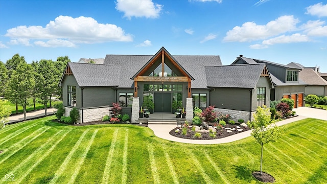 7116 Trail Ridge Ln, Indianapolis, IN 46259 - view of front of property featuring stone siding, a front lawn, roof with shingles, and a garage