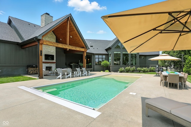 7116 Trail Ridge Ln, Indianapolis, IN 46259 - swimming pool featuring exterior fireplace, a patio area, and outdoor dining space