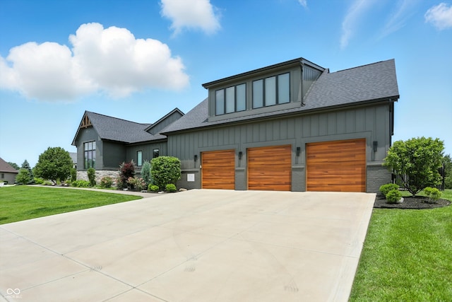 7116 Trail Ridge Ln, Indianapolis, IN 46259 - view of front of house with roof with shingles, concrete driveway, board and batten siding, and a front lawn