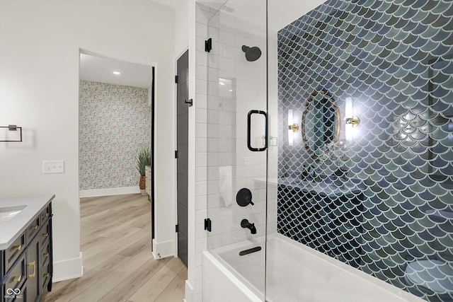 7116 Trail Ridge Ln, Indianapolis, IN 46259 - full bath with wood finished floors, bath / shower combo with glass door, vanity, and wallpapered walls
