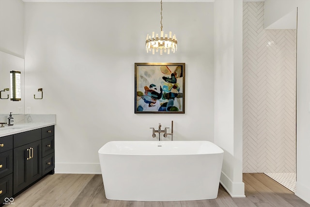 7116 Trail Ridge Ln, Indianapolis, IN 46259 - bathroom featuring a freestanding tub, vanity, and wood finished floors
