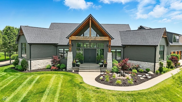 7116 Trail Ridge Ln, Indianapolis, IN 46259 - view of front facade featuring stone siding, a shingled roof, and a front yard