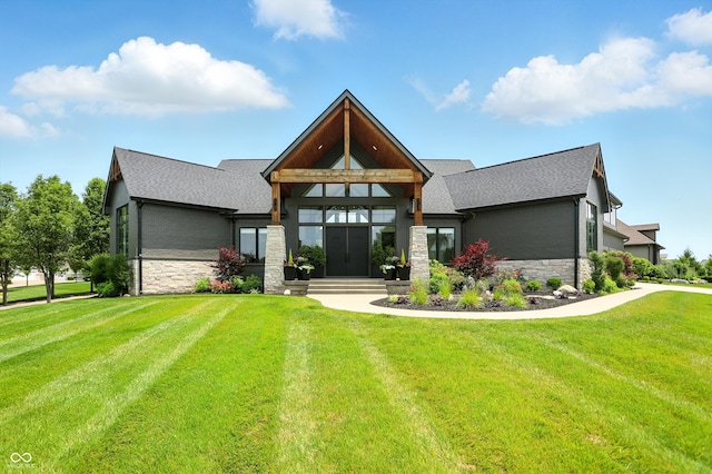 7116 Trail Ridge Ln, Indianapolis, IN 46259 - view of front of house featuring stone siding, a front yard, and a shingled roof