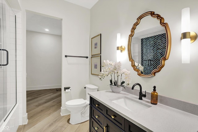 7116 Trail Ridge Ln, Indianapolis, IN 46259 - full bath featuring vanity, wood finished floors, shower / bath combination with glass door, and recessed lighting