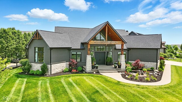 7116 Trail Ridge Ln, Indianapolis, IN 46259 - view of front of home featuring stone siding, roof with shingles, and a front lawn