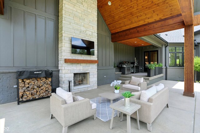 7116 Trail Ridge Ln, Indianapolis, IN 46259 - living area featuring an outdoor stone fireplace, high vaulted ceiling, a decorative wall, and a wooden ceiling with exposed beams