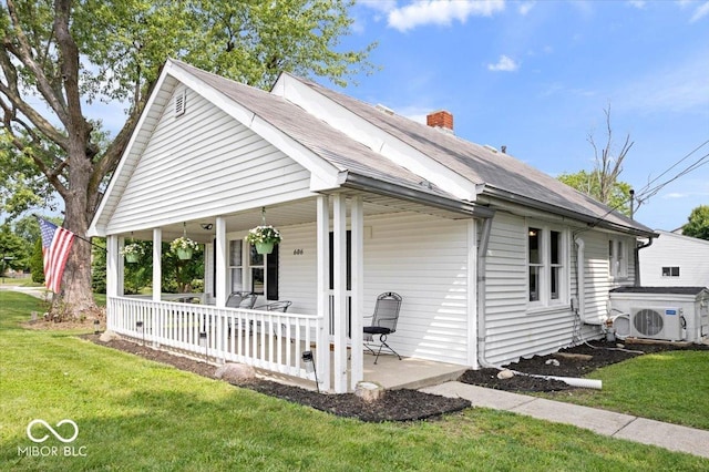 606 E County Line Rd, Indianapolis, IN 46227 - view of front facade featuring a porch, a front lawn, a chimney, and a shingled roof