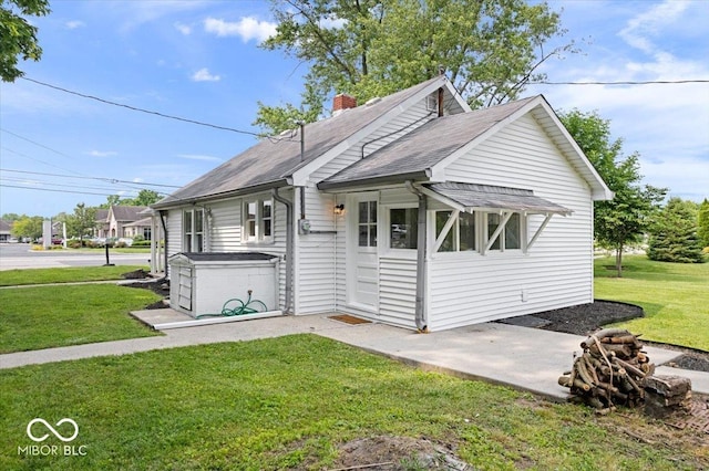 606 E County Line Rd, Indianapolis, IN 46227 - view of front of home featuring a front lawn, a chimney, and a shingled roof