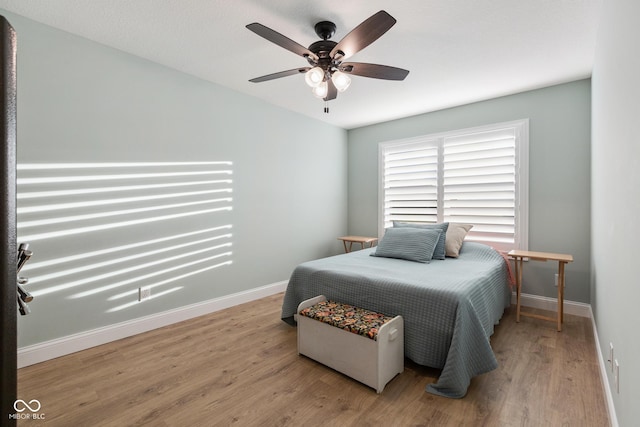 1959 Sophia Ln, Seymour, IN 47274 - bedroom featuring wood finished floors, baseboards, and ceiling fan