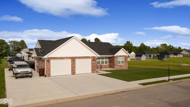 1959 Sophia Ln, Seymour, IN 47274 - view of front of property featuring a garage, driveway, a front lawn, and brick siding