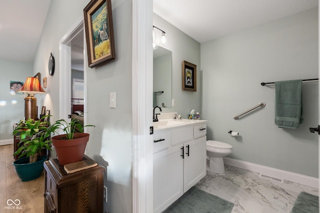 1959 Sophia Ln, Seymour, IN 47274 - bathroom with vanity, toilet, baseboards, and marble finish flooring