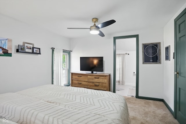 carpeted bedroom featuring baseboards, ceiling fan, and ensuite bath