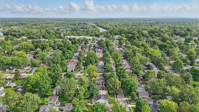 aerial perspective of suburban area featuring a heavily wooded area