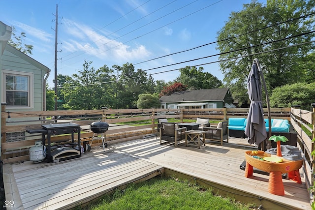 wooden terrace with a fenced backyard and an outdoor hangout area