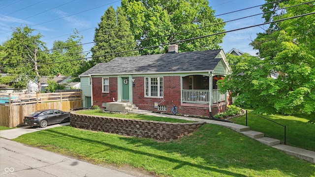 view of front of house featuring brick siding, a chimney, and roof with shingles