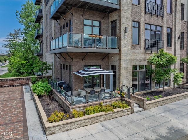 15 W Executive Dr Unit 101, Carmel, IN 46032 - rear view of house with a balcony and brick siding