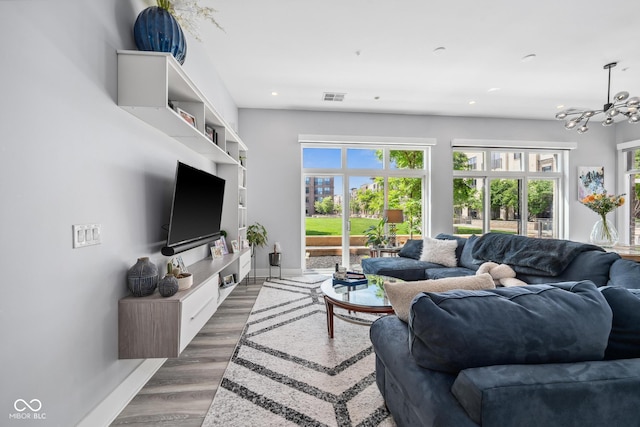 15 W Executive Dr Unit 101, Carmel, IN 46032 - living area featuring baseboards, plenty of natural light, a chandelier, recessed lighting, and wood finished floors