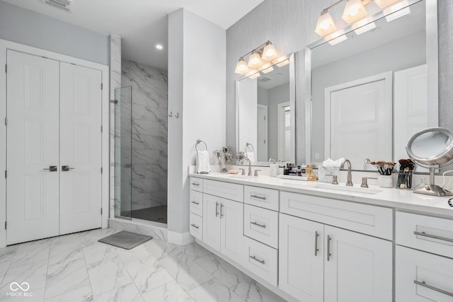 15 W Executive Dr Unit 101, Carmel, IN 46032 - bathroom with a marble finish shower, marble look tile flooring, double vanity, recessed lighting, and baseboards