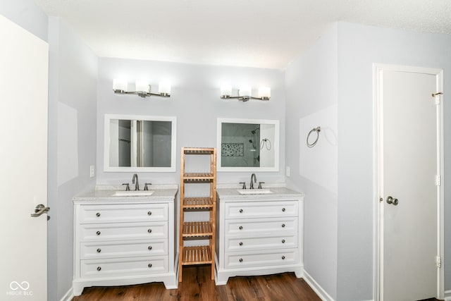 12612 Majestic Way, Fishers, IN 46037 - bathroom with wood finished floors, two vanities, a shower, and baseboards
