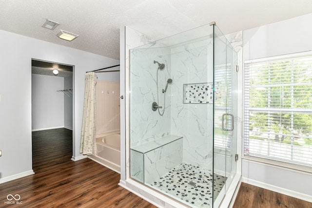 12612 Majestic Way, Fishers, IN 46037 - full bathroom featuring baseboards, wood finished floors, a textured ceiling, and washtub / shower combination