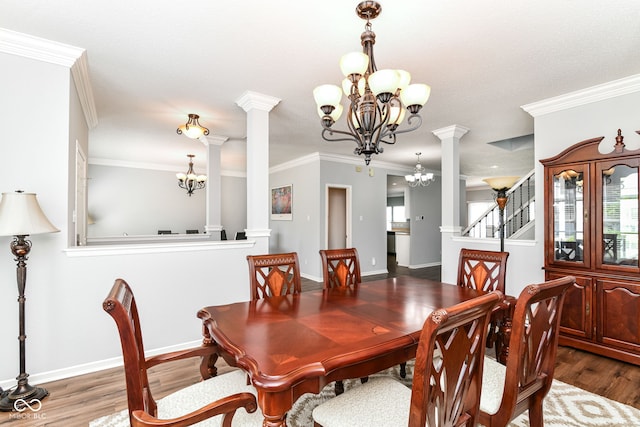 12612 Majestic Way, Fishers, IN 46037 - dining area featuring a chandelier, ornate columns, wood finished floors, and crown molding