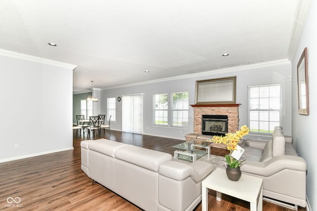 12612 Majestic Way, Fishers, IN 46037 - living room with wood finished floors, ornamental molding, baseboards, a stone fireplace, and recessed lighting