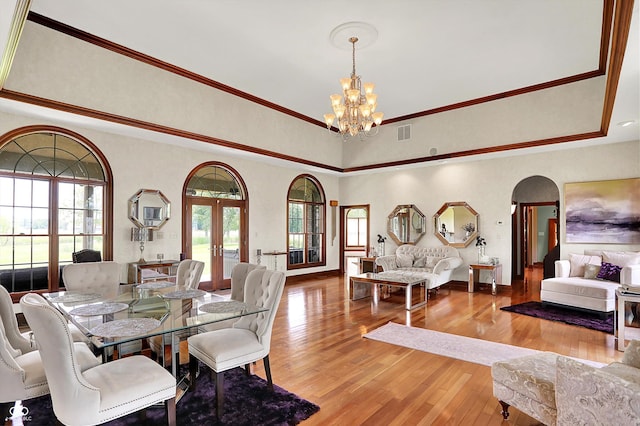 893 W 500 S, Anderson, IN 46013 - dining room featuring arched walkways, a chandelier, wood finished floors, french doors, and crown molding