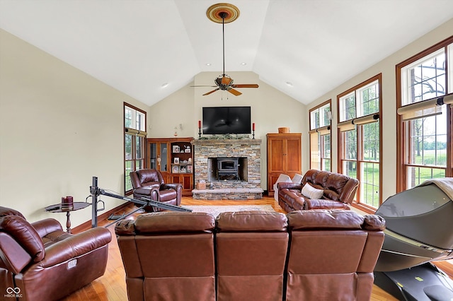 893 W 500 S, Anderson, IN 46013 - living area featuring wood finished floors, a stone fireplace, ceiling fan, and high vaulted ceiling