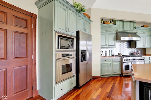 893 W 500 S, Anderson, IN 46013 - kitchen with appliances with stainless steel finishes, wall chimney range hood, wood finished floors, and light countertops
