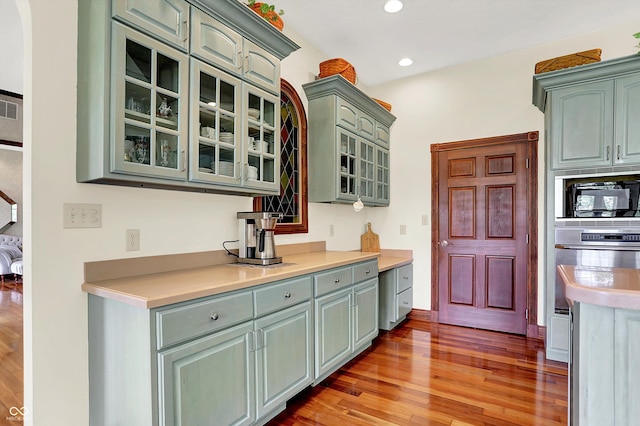 893 W 500 S, Anderson, IN 46013 - kitchen with stainless steel oven, built in microwave, green cabinetry, light wood finished floors, and recessed lighting