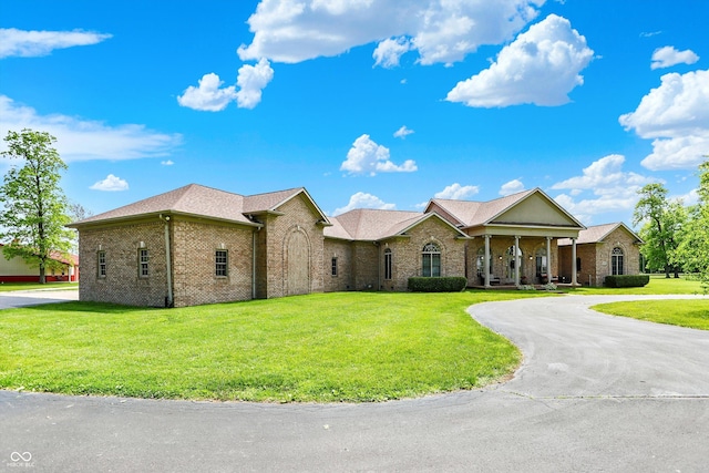 893 W 500 S, Anderson, IN 46013 - view of front of home featuring brick siding, a front lawn, curved driveway, and a porch