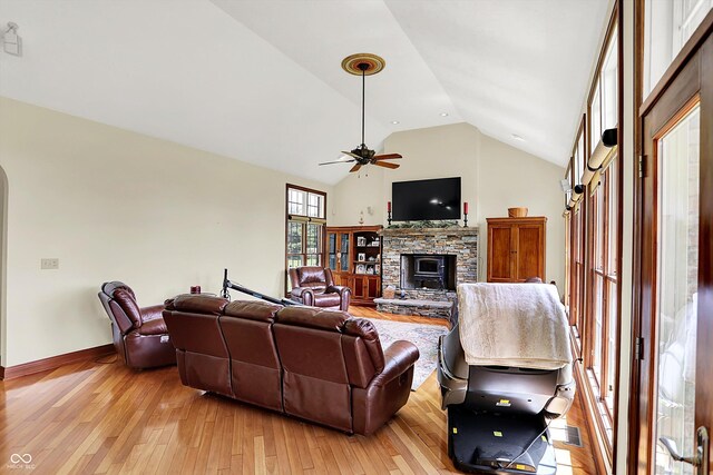893 W 500 S, Anderson, IN 46013 - living area featuring light wood-style floors, vaulted ceiling, a ceiling fan, a fireplace, and baseboards