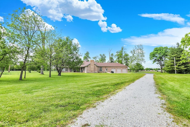 893 W 500 S, Anderson, IN 46013 - view of side of property with gravel driveway, an attached garage, a yard, and a chimney