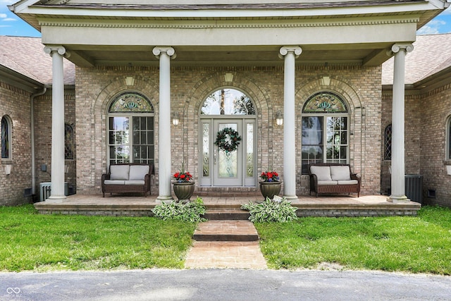 893 W 500 S, Anderson, IN 46013 - view of exterior entry featuring covered porch, brick siding, and a shingled roof