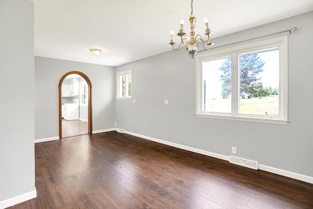 8853 S County Road 825 E, Cloverdale, IN 46120 - empty room with a chandelier, dark wood-type flooring, and arched walkways