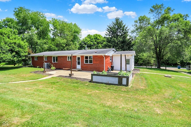 8853 S County Road 825 E, Cloverdale, IN 46120 - rear view of house featuring a patio area, brick siding, a lawn, and view of wooded area