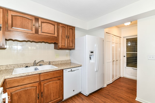 4504 Harvard Dr, Anderson, IN 46013 - kitchen with white appliances, a sink, brown cabinets, and dark wood-style flooring