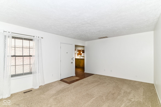 4504 Harvard Dr, Anderson, IN 46013 - carpeted empty room featuring baseboards and a textured ceiling