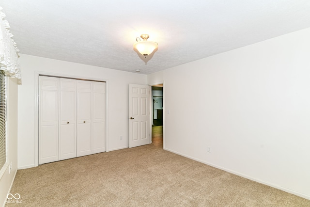4504 Harvard Dr, Anderson, IN 46013 - unfurnished bedroom featuring light carpet, baseboards, and a closet