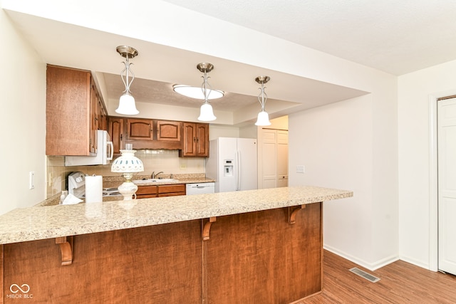 4504 Harvard Dr, Anderson, IN 46013 - kitchen with white appliances, a peninsula, light countertops, and baseboards