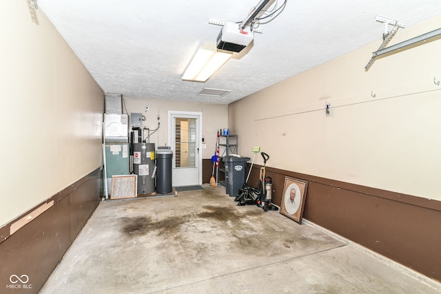 4504 Harvard Dr, Anderson, IN 46013 - garage featuring electric water heater and a garage door opener