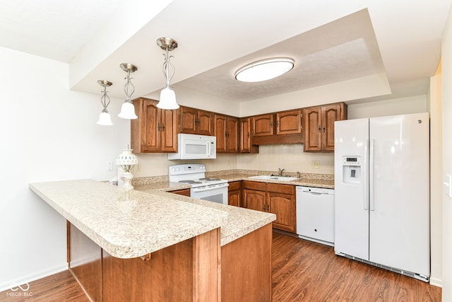4504 Harvard Dr, Anderson, IN 46013 - kitchen featuring white appliances, a peninsula, light countertops, and brown cabinetry
