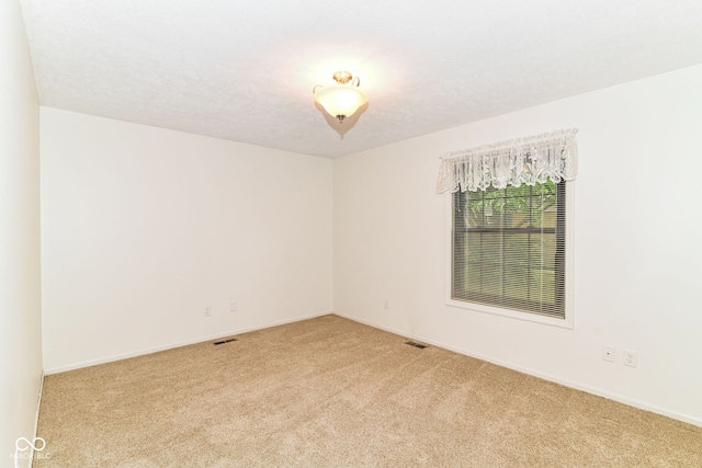 4504 Harvard Dr, Anderson, IN 46013 - spare room featuring light carpet and baseboards