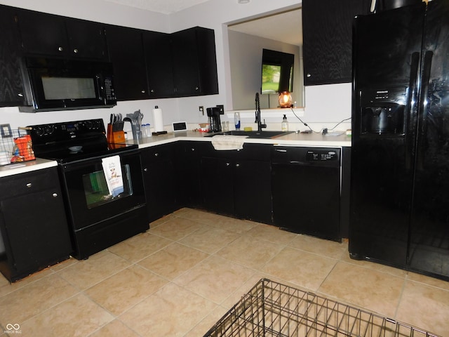 1612 Prairieview Ln, Greenfield, IN 46140 - kitchen with dark cabinetry, black appliances, light countertops, and light tile patterned floors