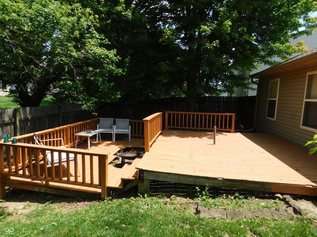 1612 Prairieview Ln, Greenfield, IN 46140 - wooden deck with a fenced backyard and an outdoor fire pit