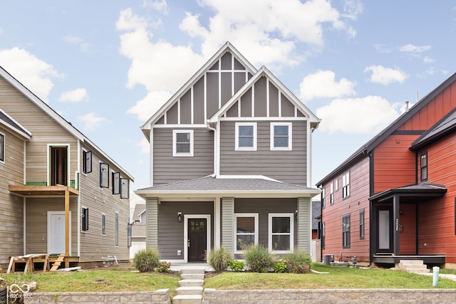 2024 Yandes St, Indianapolis, IN 46202 - view of front of house with board and batten siding, a front yard, entry steps, and central air condition unit