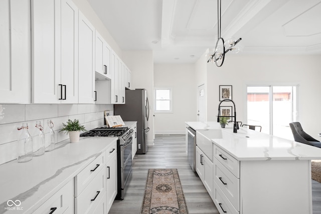 2024 Yandes St, Indianapolis, IN 46202 - kitchen with stainless steel appliances, a sink, wood finished floors, white cabinetry, and crown molding
