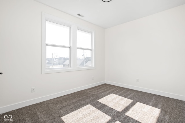 2024 Yandes St, Indianapolis, IN 46202 - spare room with dark colored carpet and baseboards