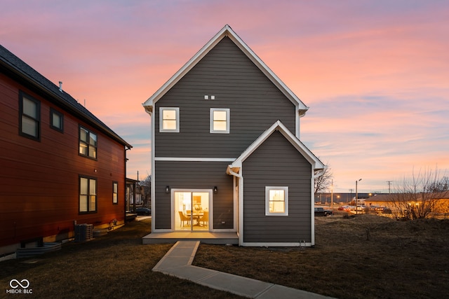 2024 Yandes St, Indianapolis, IN 46202 - back of property at dusk with cooling unit and a lawn